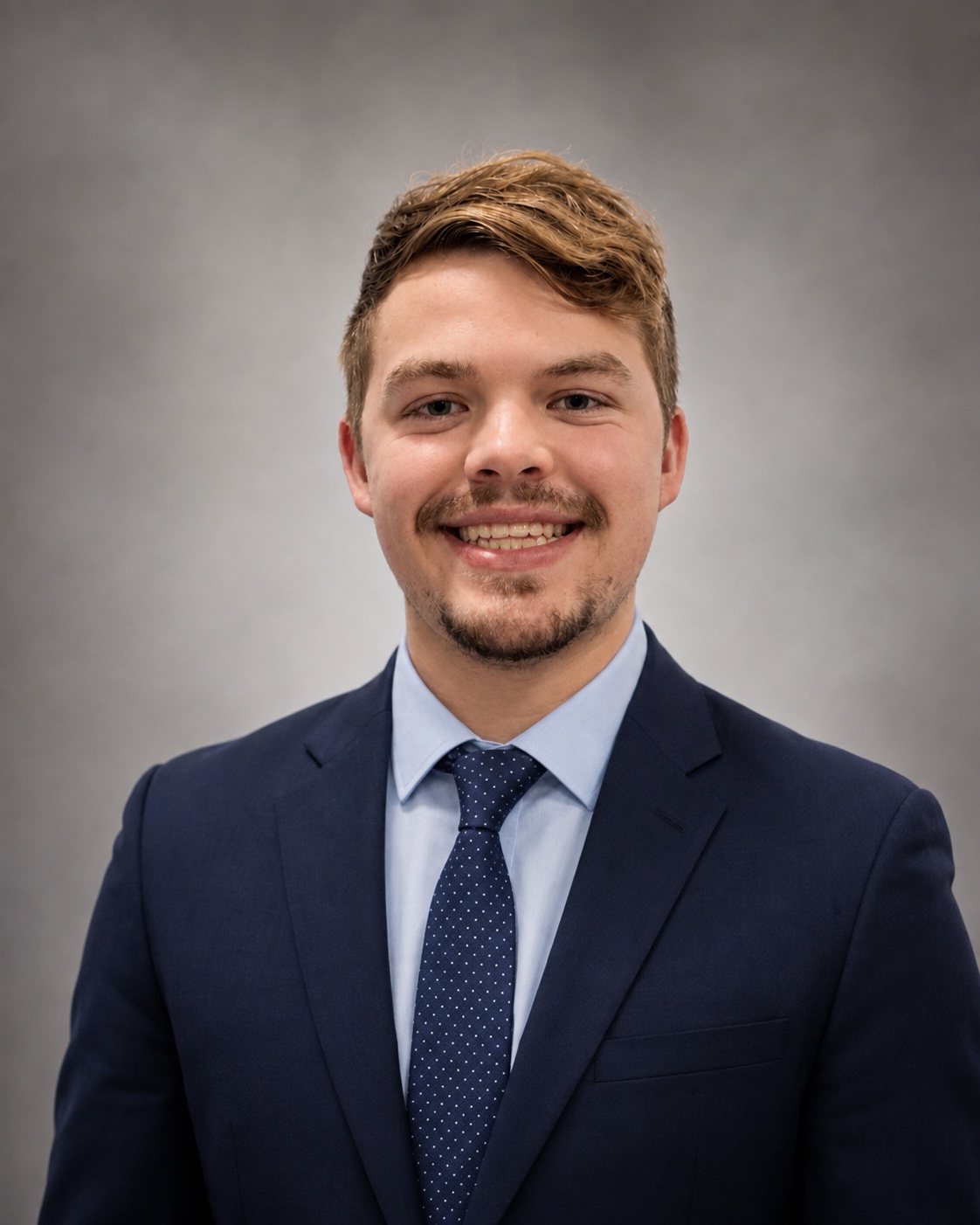 Alex Kluge in professional attire